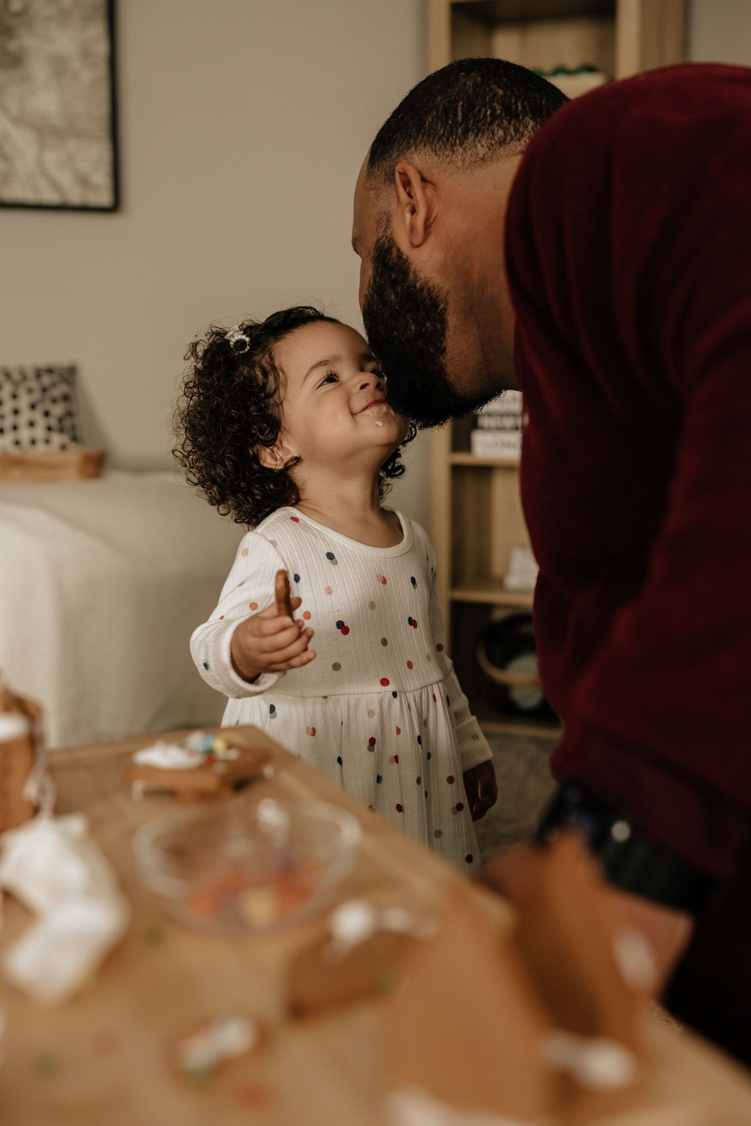 A heartwarming interaction between adult and child while crafting together at home.