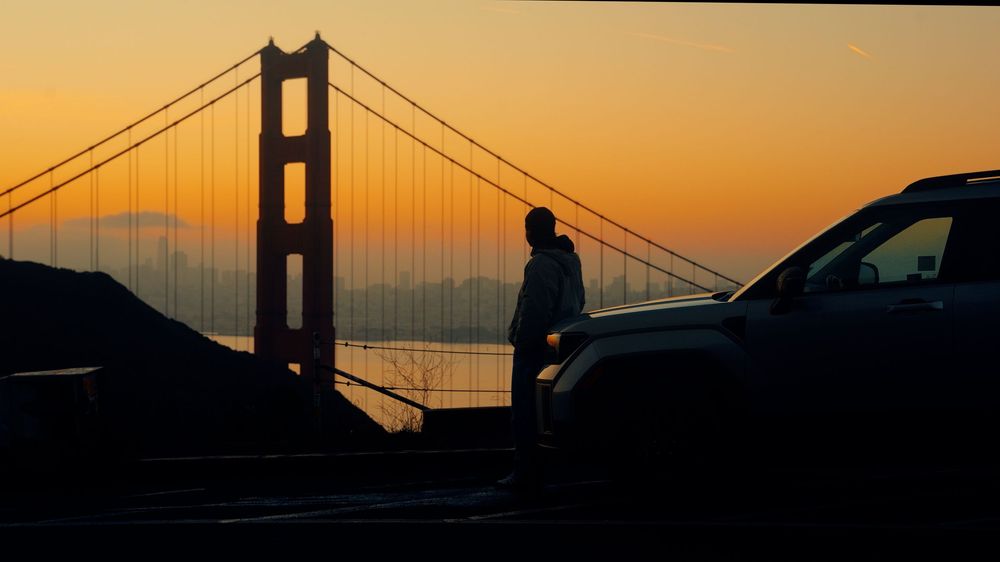 Golden Gate Bridge silhouetted against vibrant orange sunset sky in San Francisco.