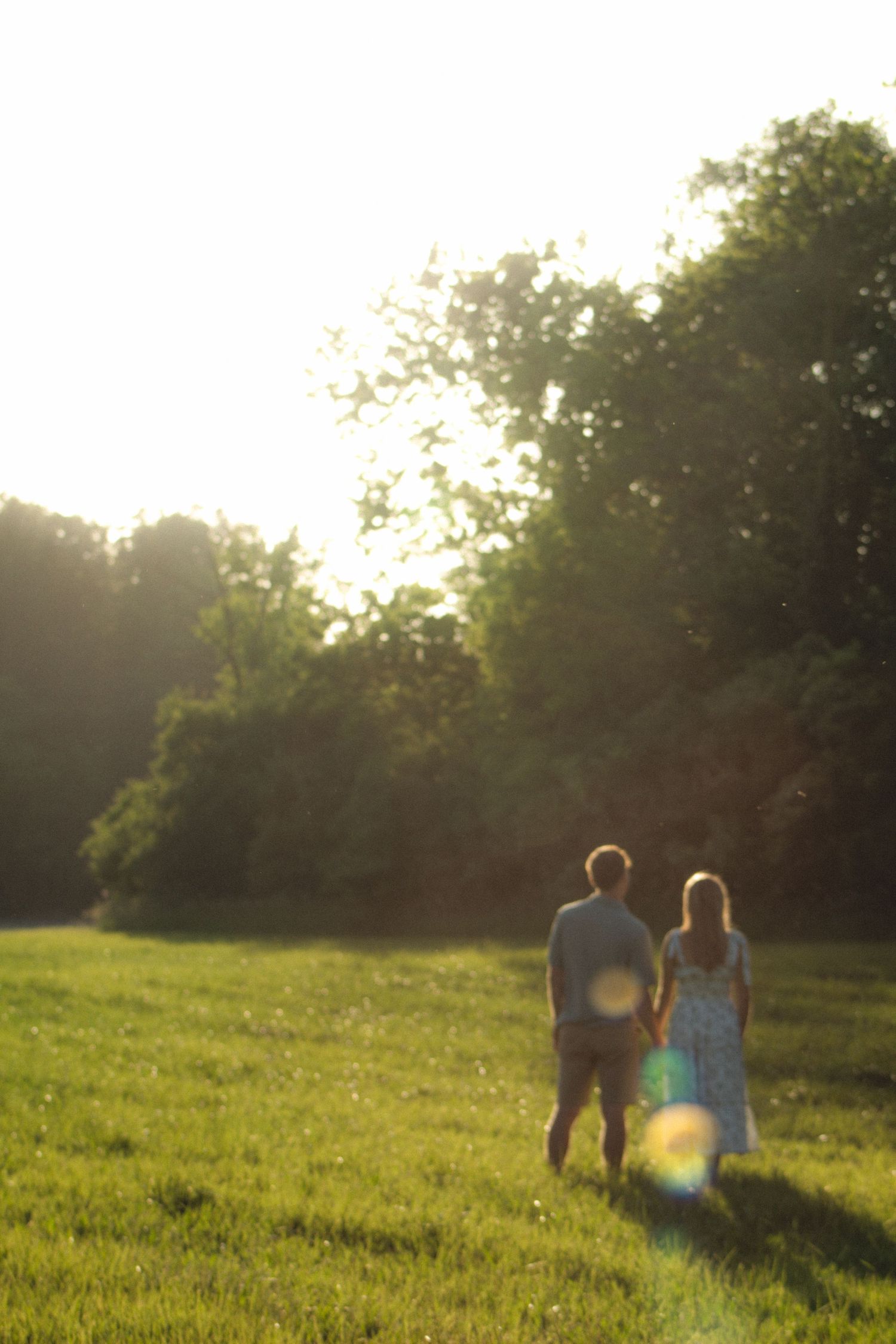a couple holding hands in the distance