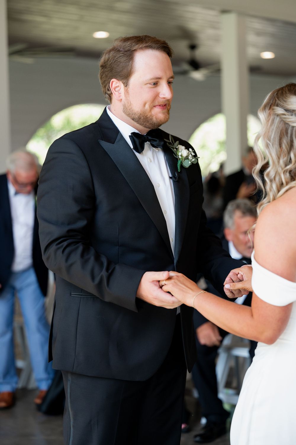 A first look wedding moment captured between a couple in formal attire.