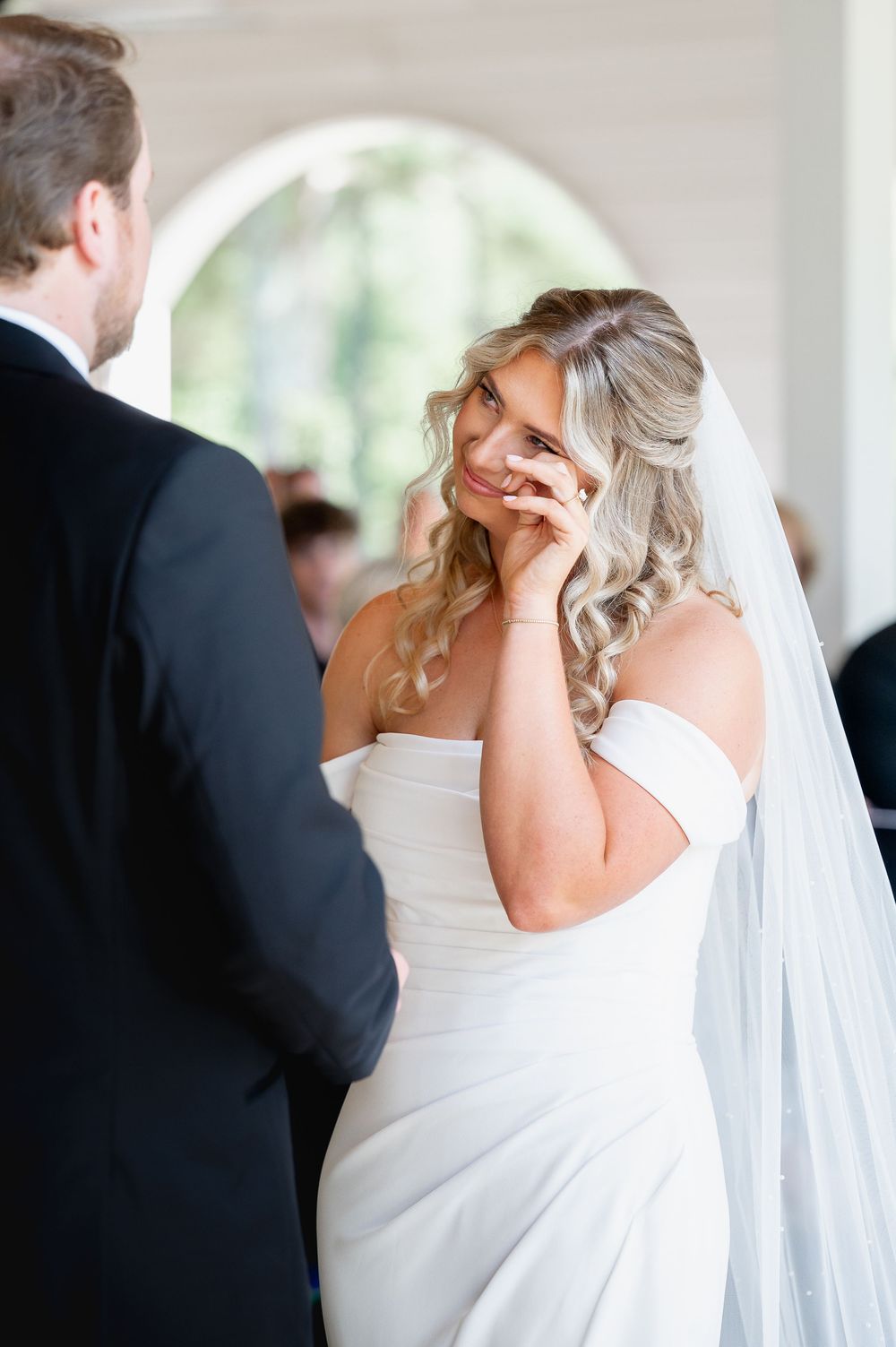 An intimate first look moment between newlyweds in a bright indoor venue.
