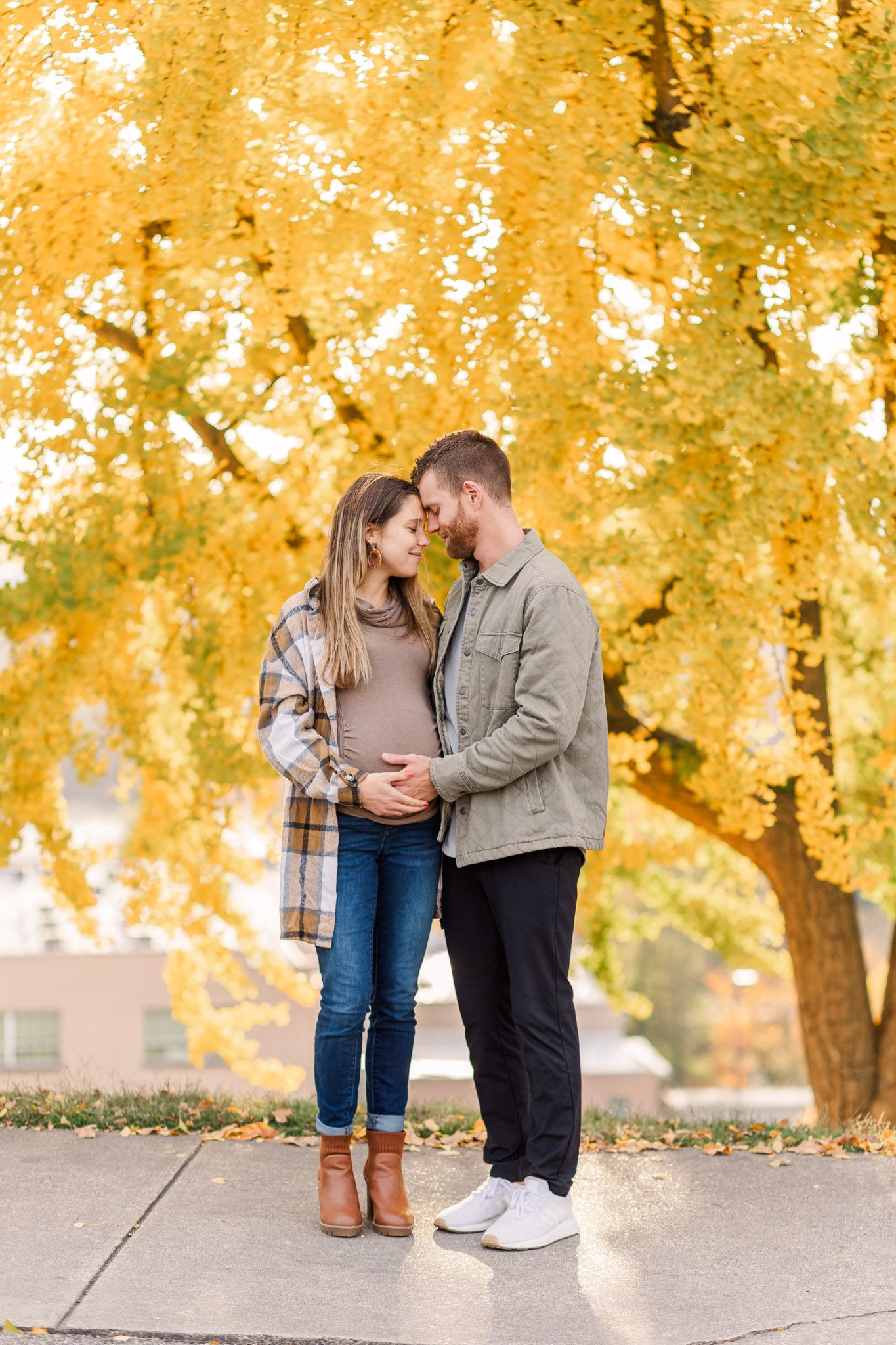 Libby Hill maternity photo session with a couple snuggling face to face while embracing the baby bump