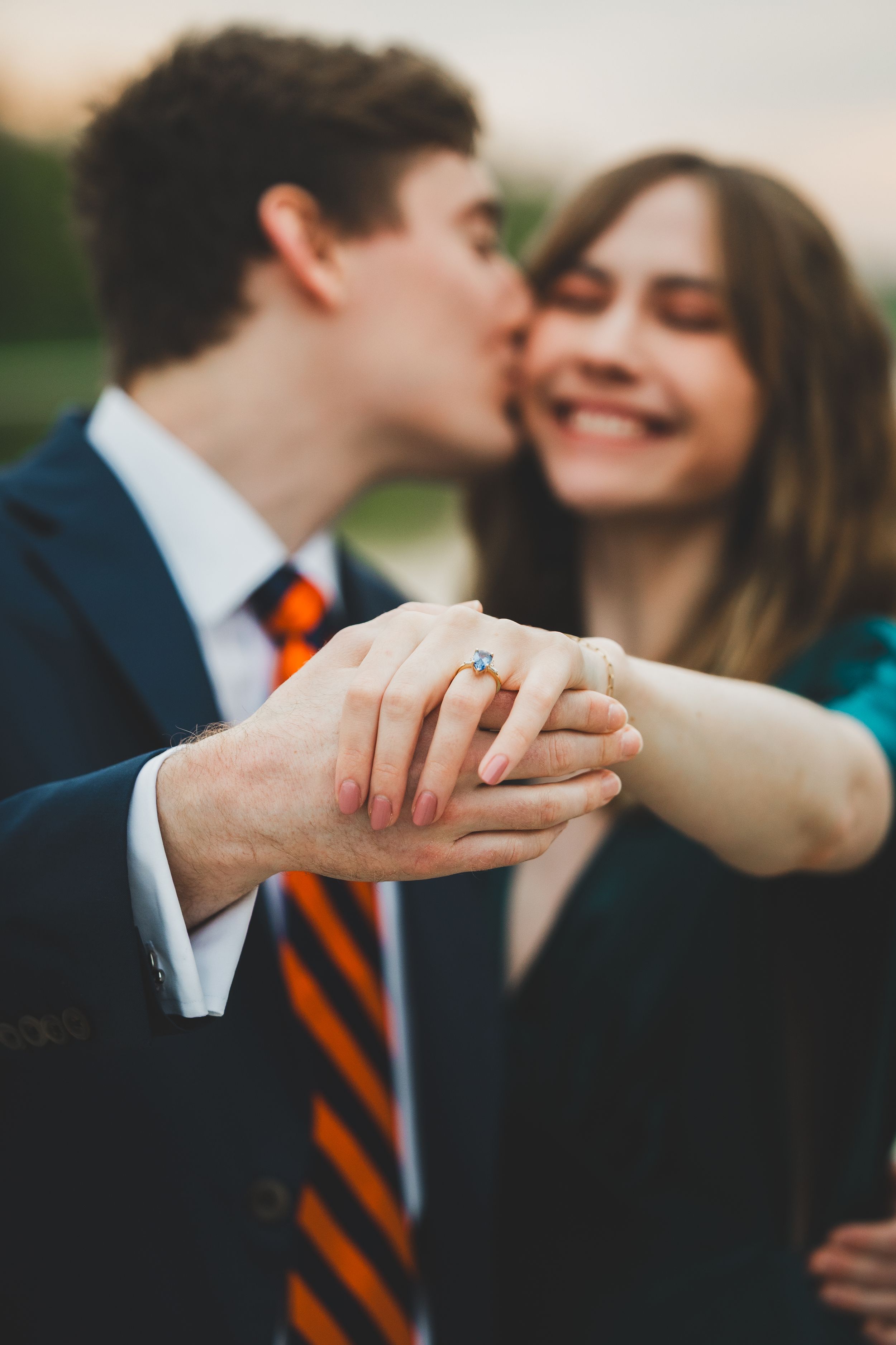 Close-up series of hands showing a couple's romantic engagement moment with an orange striped tie visible in the background.