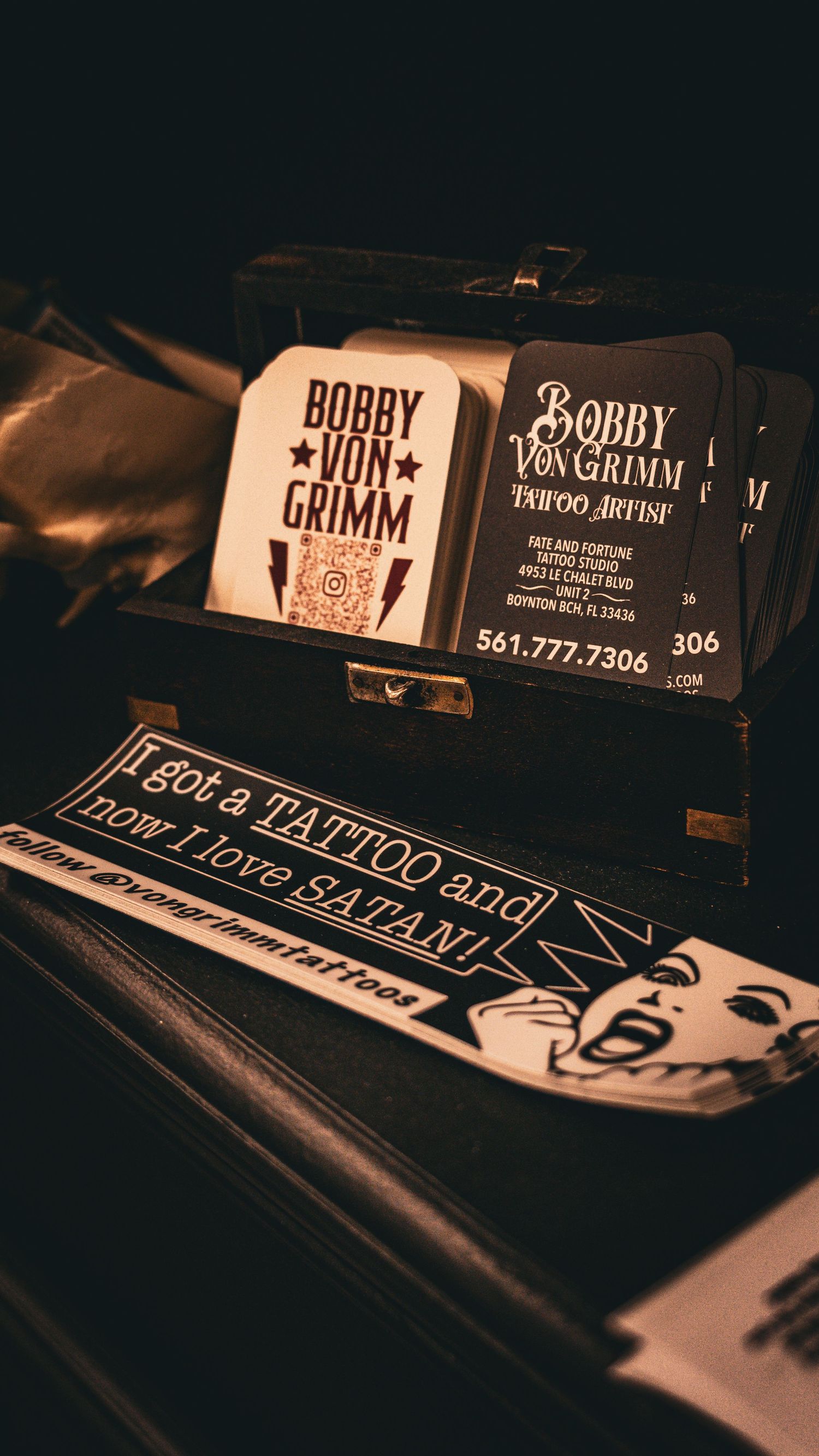 Business cards and branding materials for Bobby Von Grimm tattoo services displayed in vintage style.