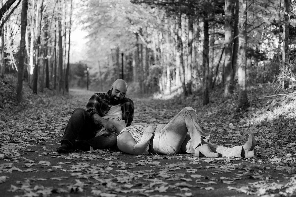 A series of black and white photos showing people relaxing and lounging in a wooded forest setting.
