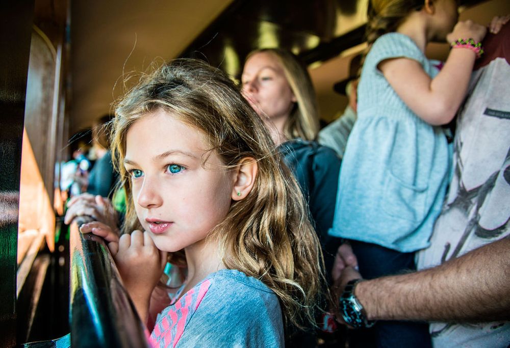 A candid closeup shot in blue tones captured at an indoor gathering.
