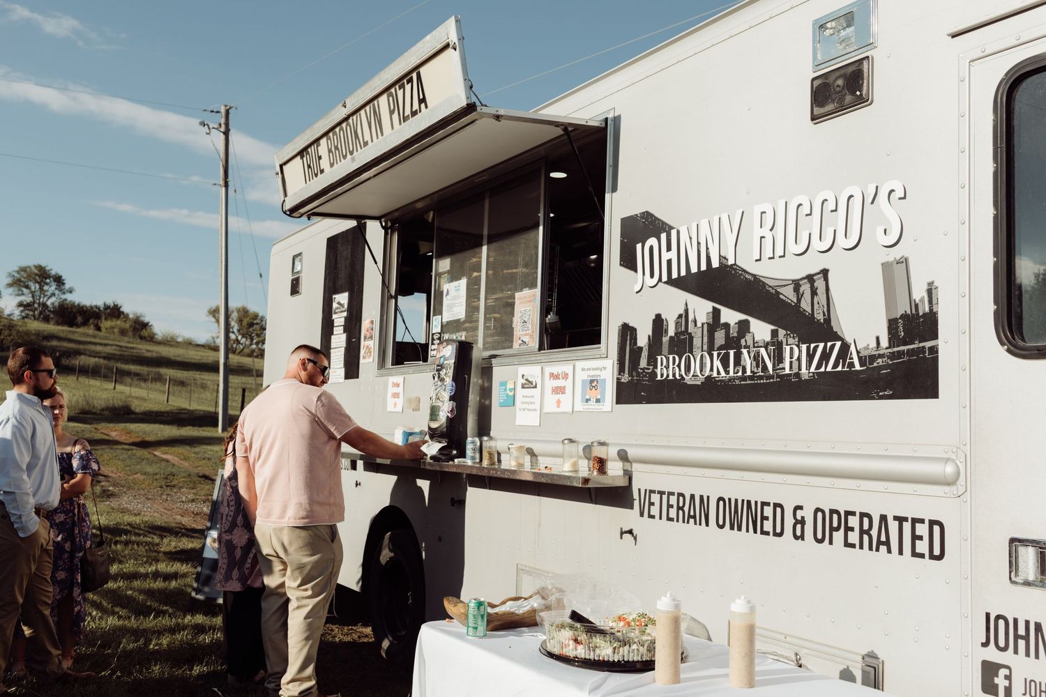 Johnny Riccos Brooklyn Pizza food truck serving guests at an outdoor wedding reception.