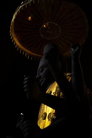 Illuminated stone carvings and architectural details at Angkor Wat temple complex at night.