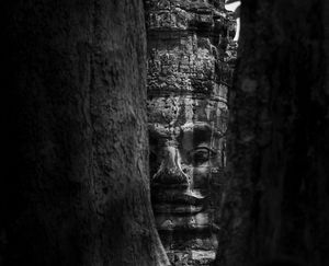 Dark stone corridors and passageways within the ruins of Angkor Wat temple.