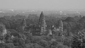 Panoramic aerial view of Angkor Wat temple complex surrounded by jungle landscape.