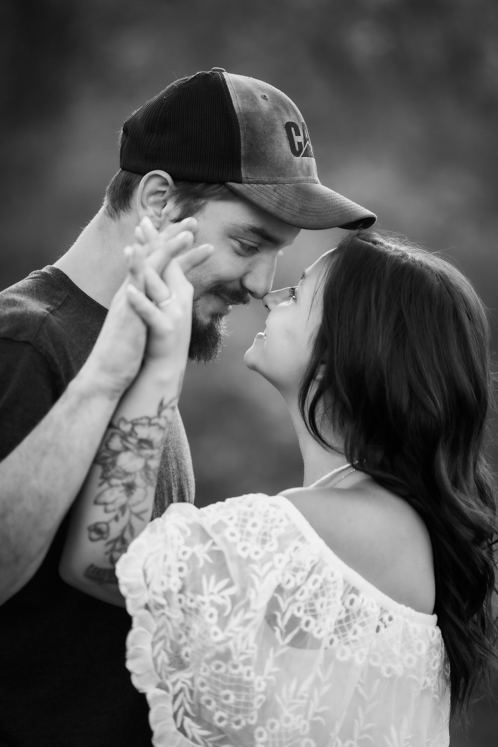 Intimate black and white portrait of couple sharing a tender moment.