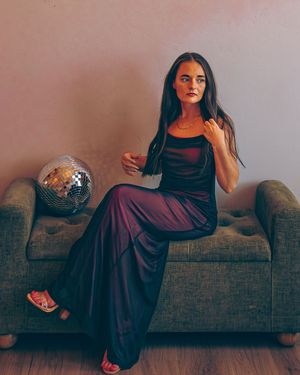A person in dark clothing poses on a gray couch in a dramatic photo sequence.