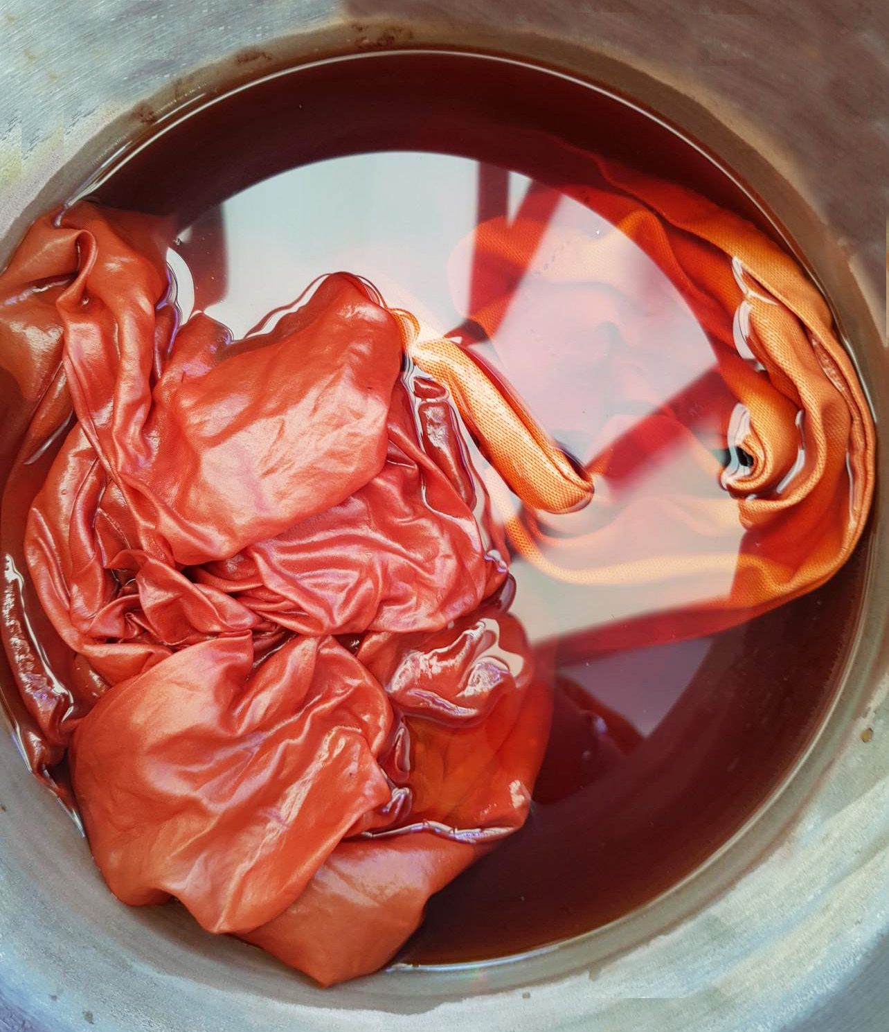 wet naturally dyed cloth in a pot of dye