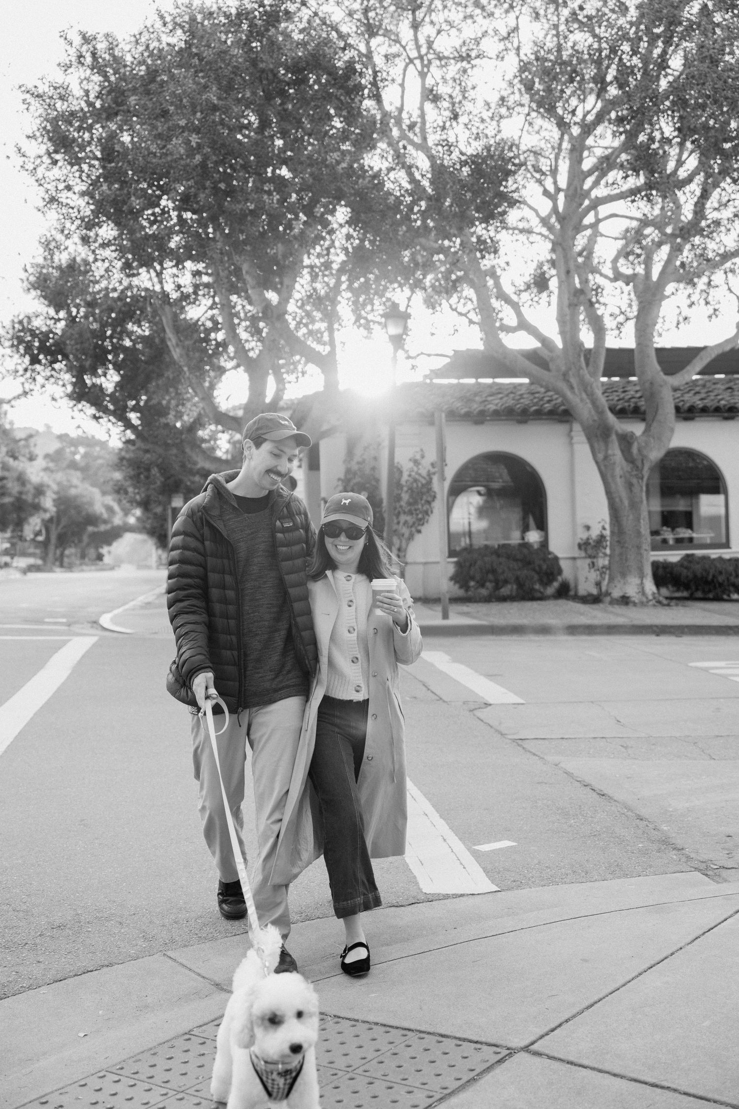 Candid timeless moment of engagement couple with dog in downtown Carmel, CA