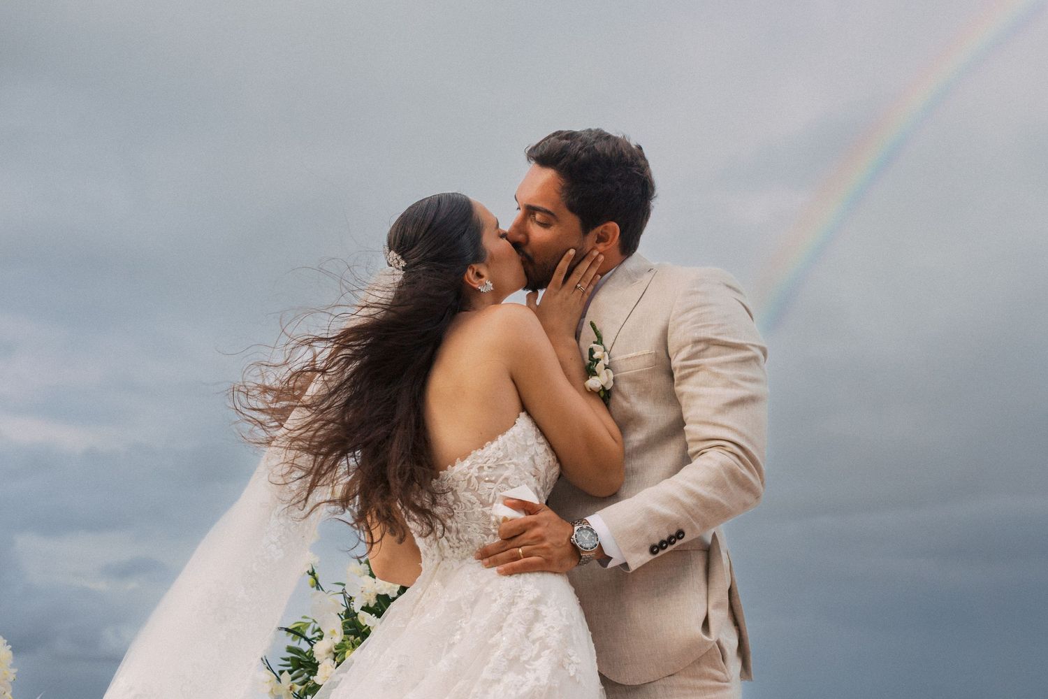 Intimate wedding ceremony moment inside a bright white chapel.