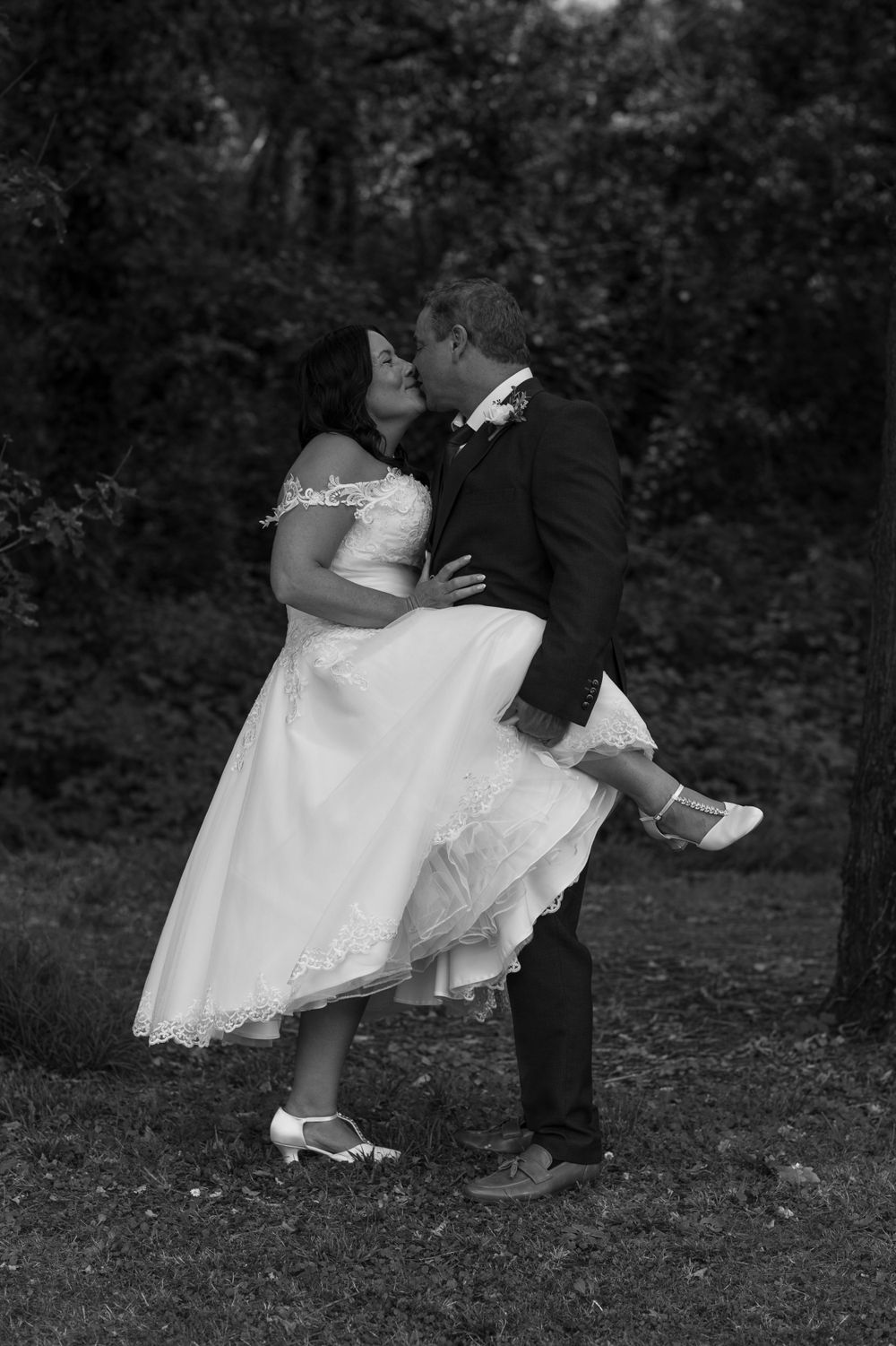 Black and white romantic wedding photo with tea-length dress.