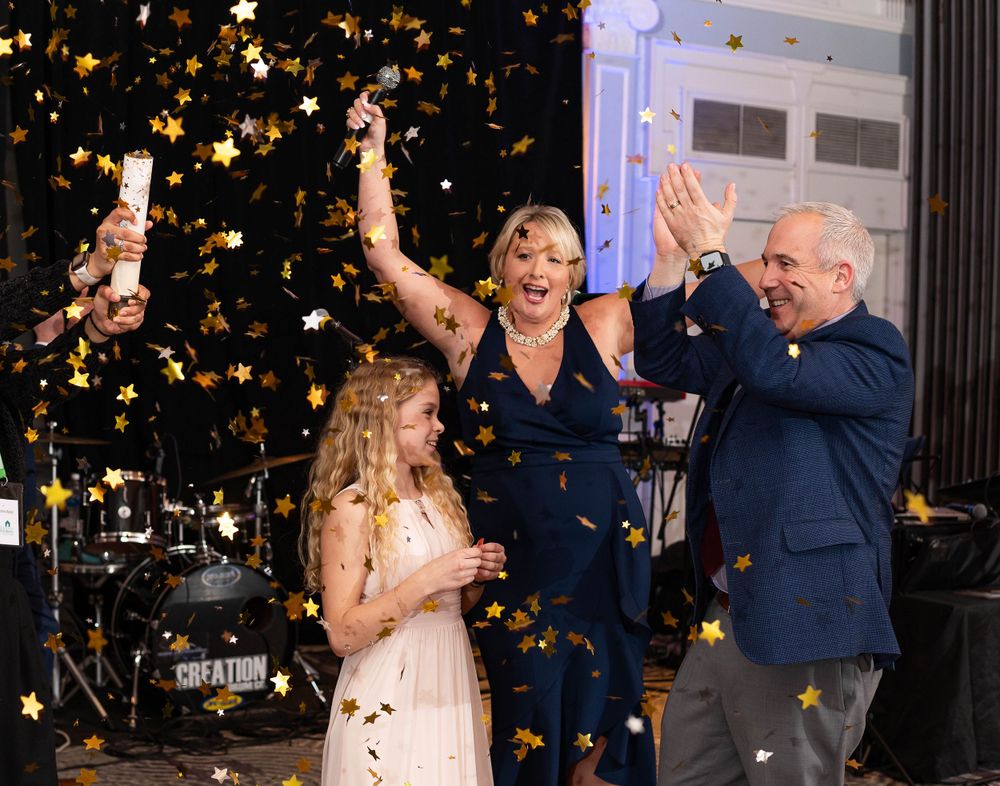 Celebrating the raffle winner sat Homeless Solutions Bash Charity Gala