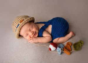 Newborn pictures as fisherman. Angelic sleeping pose. Newborn profile portrait. Arkansas Newborn Photographer.