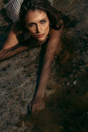 a beautiful woman lying down in water in Mallorca