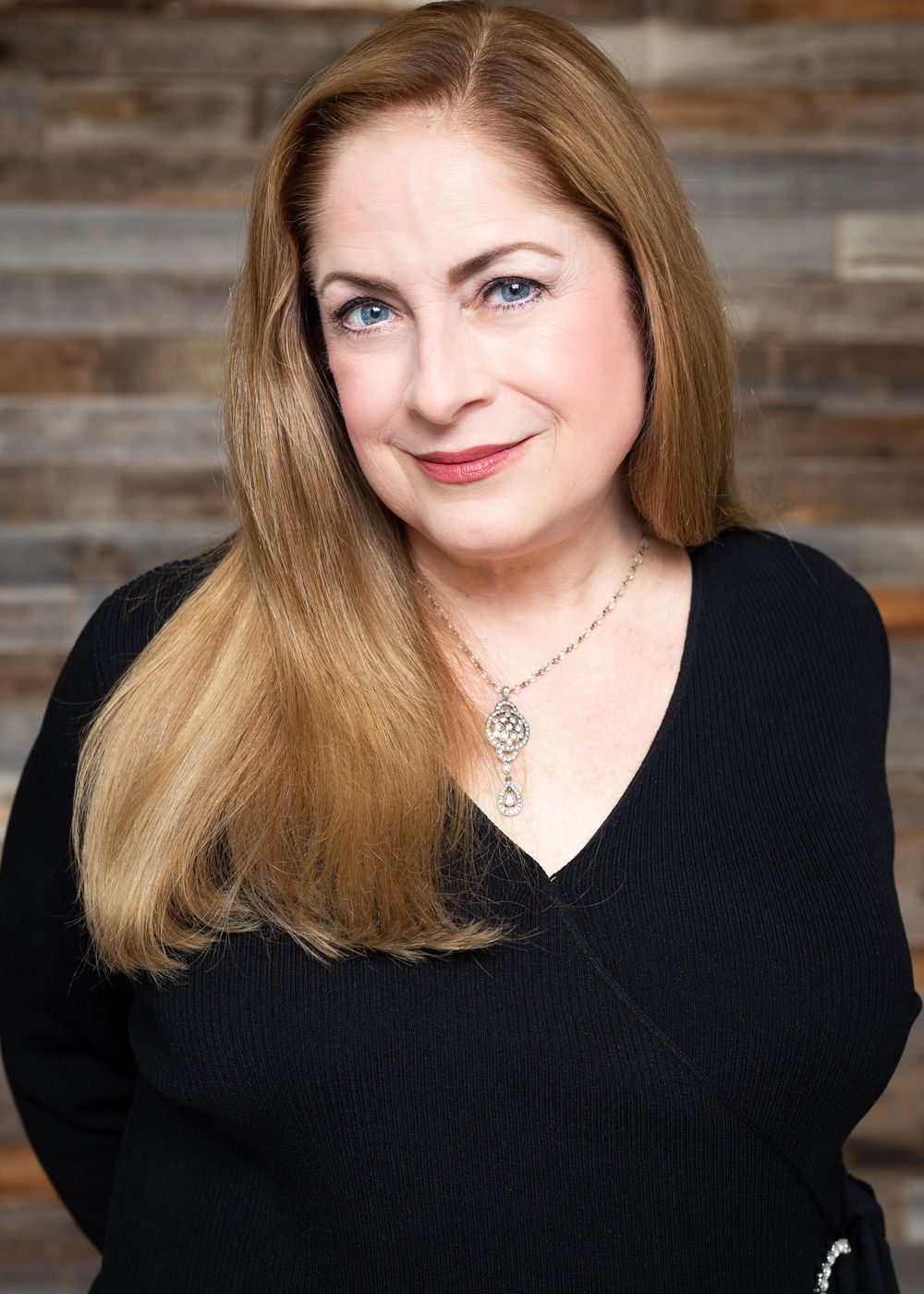 Studio portraits of a woman in black against wooden backdrop showing various expressions.