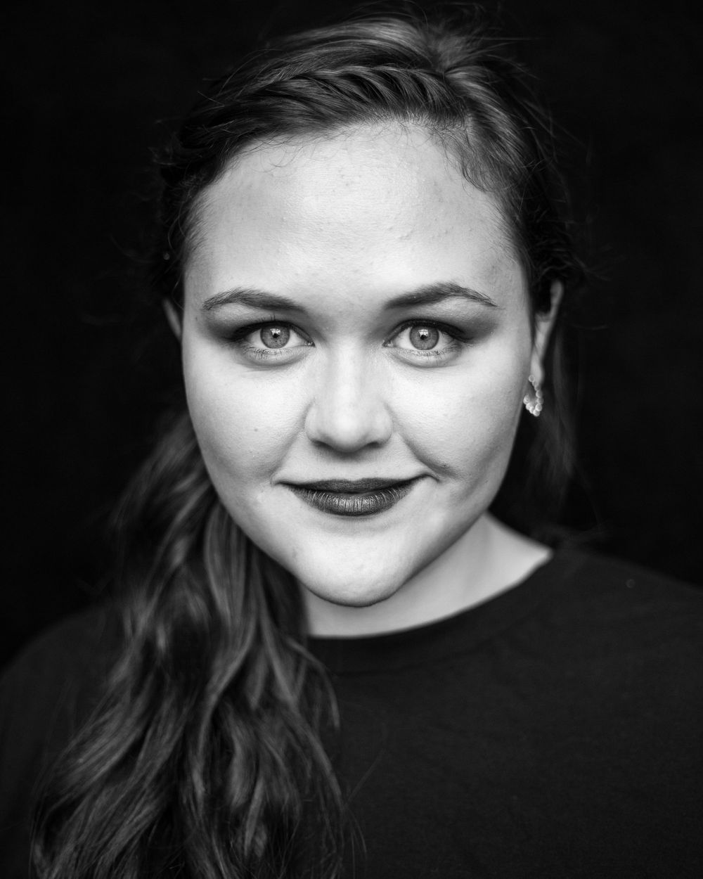 Dramatic black and white close-up portrait series with dark background.