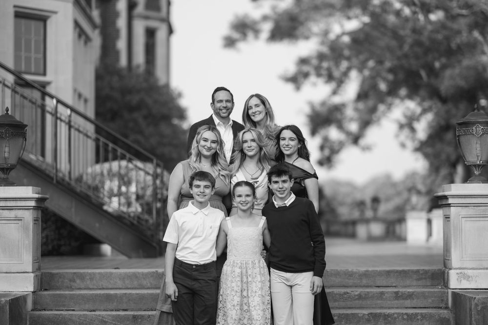 A series of black and white family portrait photographs arranged in a horizontal collage showing multiple group poses.