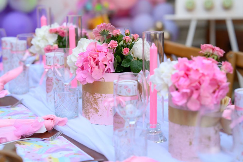 Beautiful table setting with pink floral centerpieces and crystal glassware for special occasion.