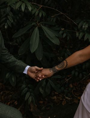 a bride leads her groom by the hand through the laurels in Western North Carolina near Asheville and Boone