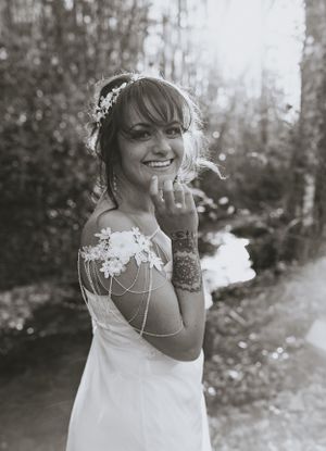 a monochrome shot of a bride with an arm jewelry and a cheeky smile