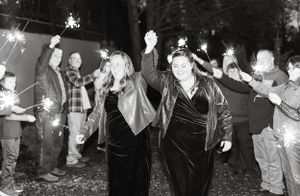 two brides celebrate a grand entrance to their wedding reception