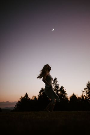 dancing in the moonlight in the glow of blue hour in Western North Carolina just outside of Asheville