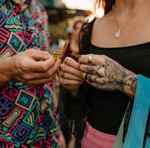 a couple in colorful clothing share a yellow carnival ticket in Western North Carolina near Asheville and Boone