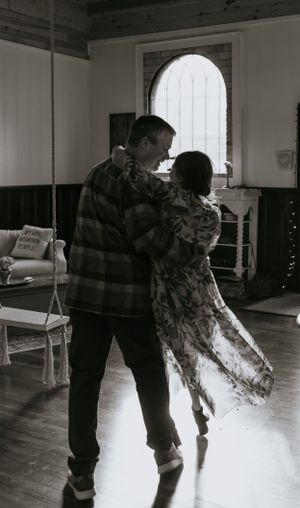 a man dips his wife in front of a window