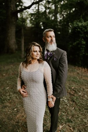a couple stands in nature for their wedding portraits in Western North Carolina just outside of Asheville