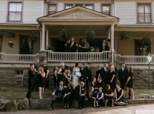 a large family photo after a wedding some are standing and some are sitting