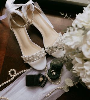 shoes, wedding rings, and a bouquet await a bride