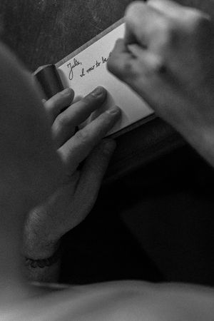 a man writes his vows in monochrome