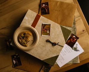 a chocolate chip cookie sits on a plate on top of a photo scrap book in Western North Carolina near Asheville