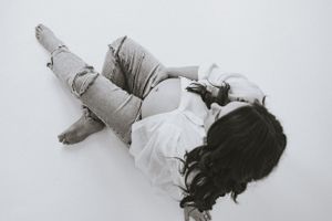 an ariel black and white view of a pregnant woman with a white shirt unbuttoned