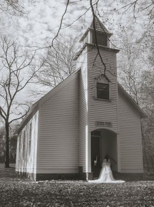 a monochrome shot of the chapel at Cataloochee Valley with a couple standing in the doorway