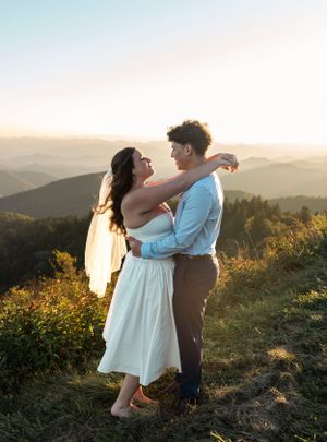 a couple got married on the Blueridge Parkway in Western North Carolina they hug with the mountains in the background
