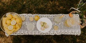 a long table containing lemons to make lemonade