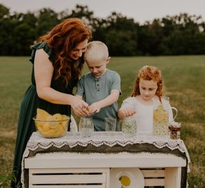 a mother helps her children make lemonade outside in Western North Carolina near Asheville