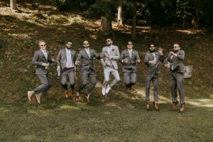 a groom and his boys jump for joy