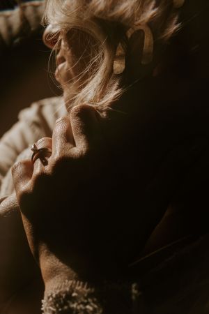 a bride lovingly clutches the hand of her partner as golden light illuminates in Western North Carolina just outside of Asheville
