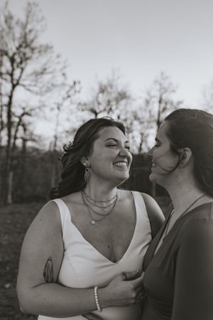 two brides in black and white smiling