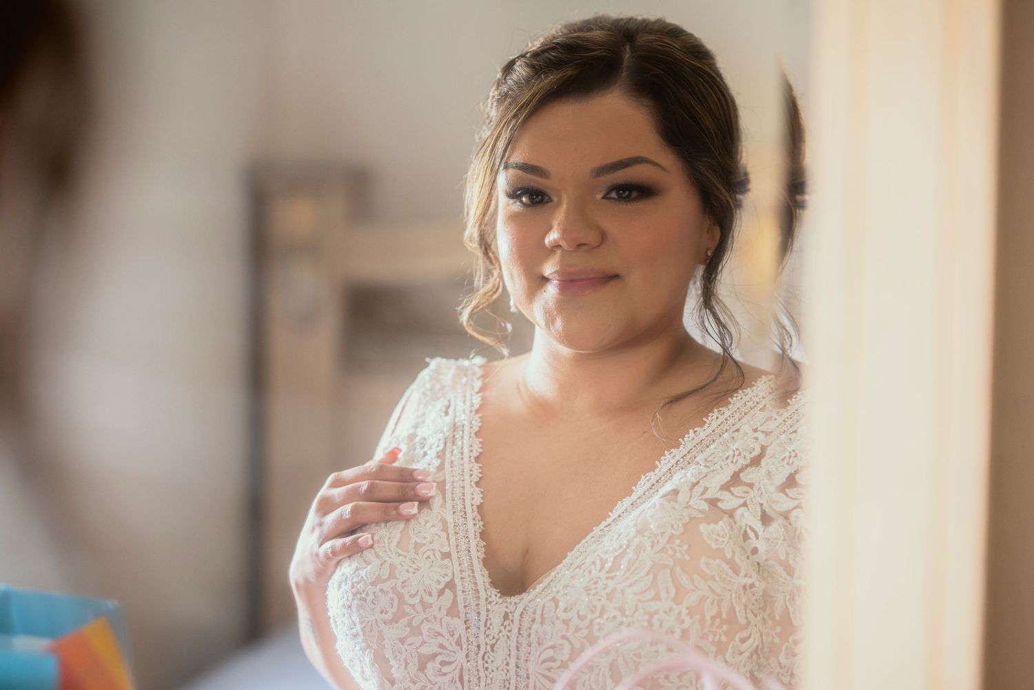 Wedding photography of bride looking at herself in the mirror