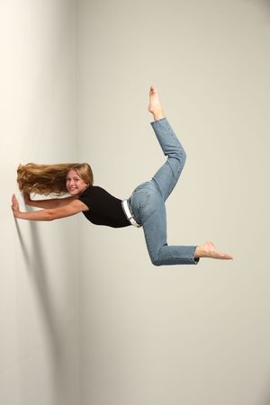 Horizontal sequence showing a person floating and turning upside down against a white studio backdrop.