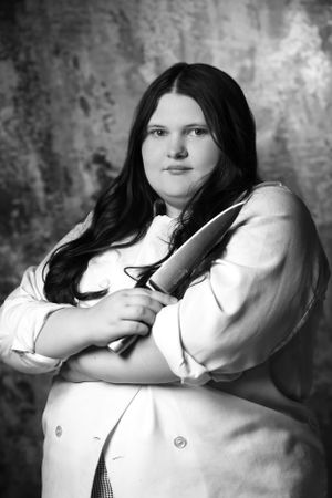 Dramatic black and white portrait with vintage style white blouse and dark hair.