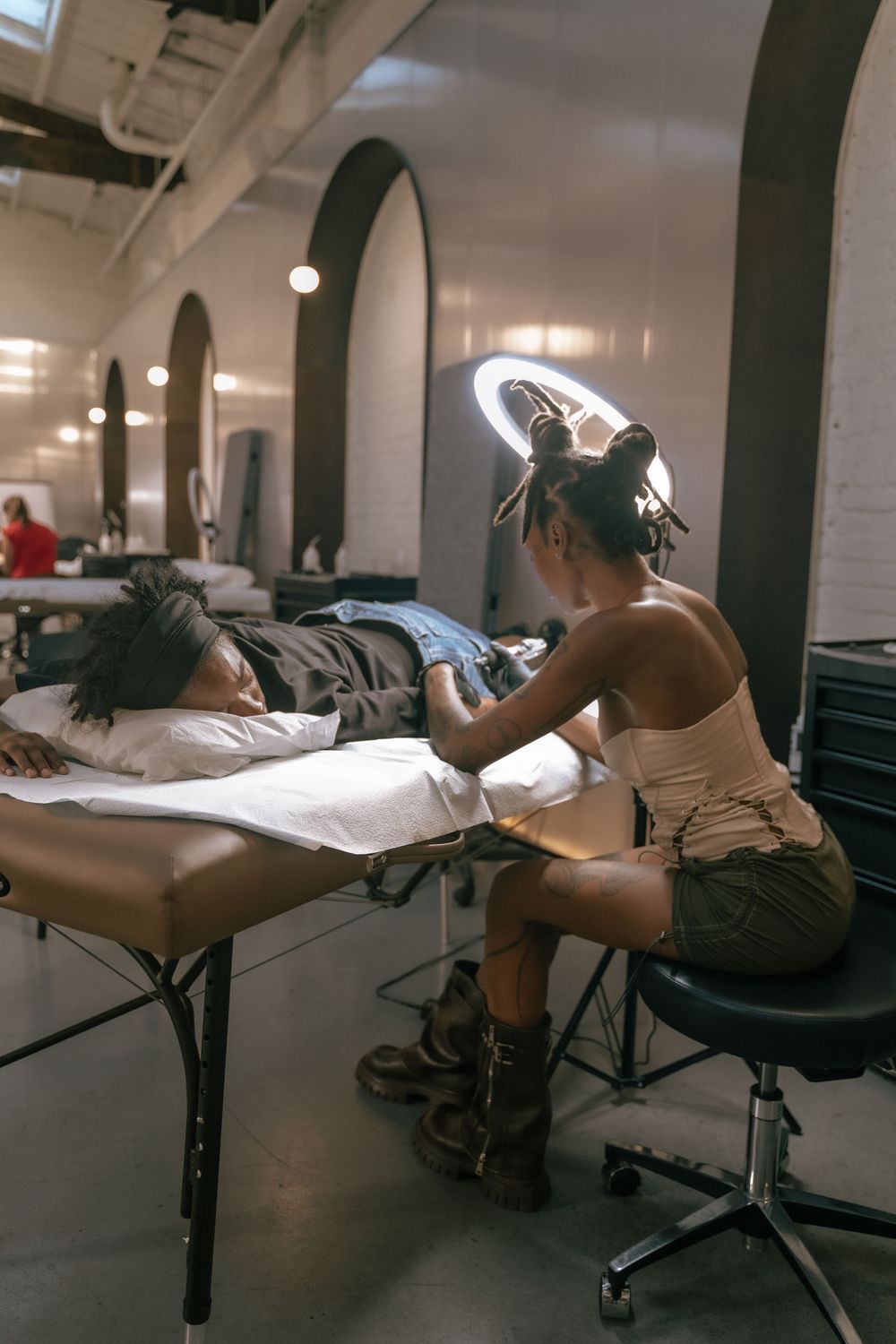 Massage therapy session in progress in spa treatment room with arched doorways.